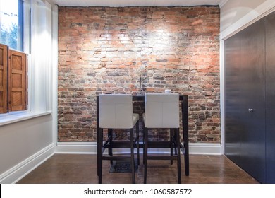Inviting bar table in front of exposed brick