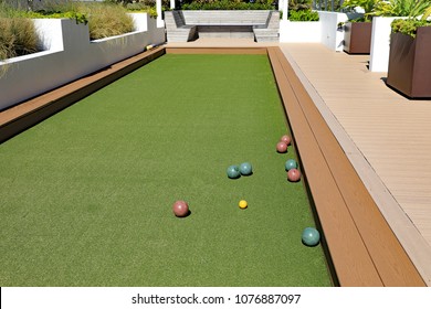 An Inviting Bocce Ball Court With Artificial Turf, On A Rooftop Terrace At A Condo In Florida.