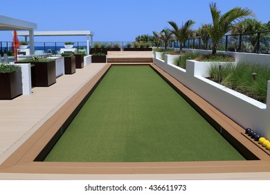 Inviting Bocce Ball Court With Artificial Turf On A Rooftop Terrace.