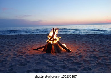 Inviting campfire on the beach during the summer, bring back fond memories.  Fun and good times at the lake.