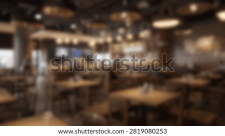 An inviting restaurant interior featuring tables, chairs, and ambient lighting, creating a warm and welcoming atmosphere for diners.