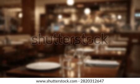 An inviting restaurant interior with tables elegantly set for dining, featuring warm ambient lighting and a cozy atmosphere.