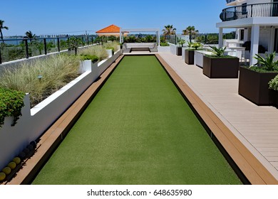 Inviting Rooftop Bocce Ball Court And Terrace At An Oceanfront Condo.