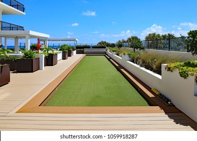 An Inviting, Upscale Bocce Ball Court With Artificial Turf, On An Outdoor Oceanfront Terrace At A Condo Ready For Friends And Family To Play. 