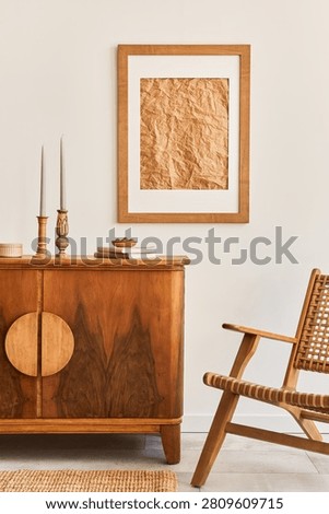 An inviting and warm interior features classic and modern wooden furniture, a framed art print, and decorative items. Perfect for home decor concepts