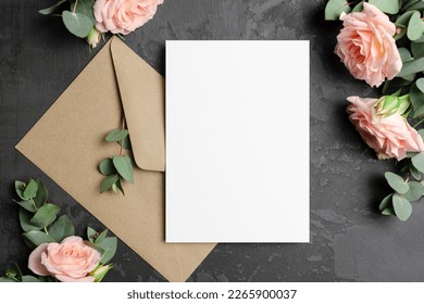 Invntation or greeting card mockup with envelope and roses flowers on dark background, blank mockup - Shutterstock ID 2265900037