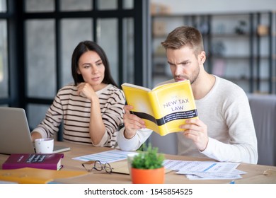 Involved In Studying. Blue-eyed Handsome Husband Feeling Involved In Studying New Tax Law