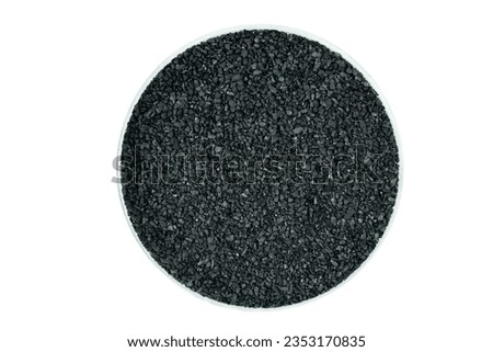 Ion-exchange Anthracite for water softening beads or granules texture background. Anthracite water filter for residential drinking or industrial texture surface isolated on white background,top view