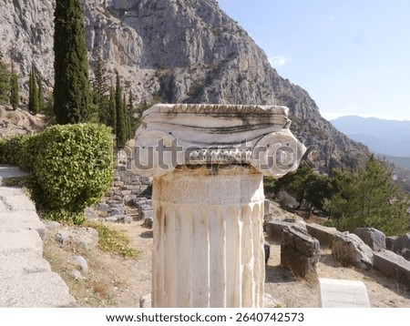 Ionic Column in Delphi Surrounded by Trees with Mountains in the Background