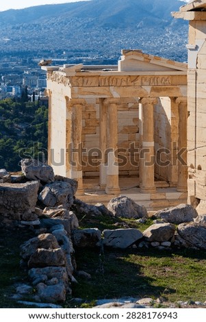 Ionic columns of the ancient Temple of Athena Nike overlooking the Athens cityscape.