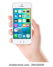 iOS 9 homescreen on the white Apple iPhone 5s display in female hand. iOS 9 is a mobile operating system created and developed by Apple Inc. Isolated on white background. Bulgaria - February 02, 2015.