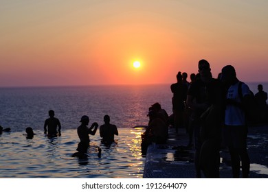 Ios, Greece - July 31, 2019 : Young People Gather Around A Swimming Pool To Watch The Sunset In Ios Greece 