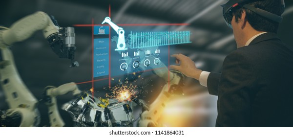 iot industry 4.0 concept,industrial engineer(blurred) using smart glasses with augmented mixed with virtual reality technology to monitoring machine in real time.Smart factory use Automation robot arm