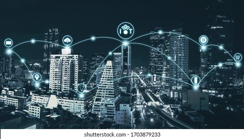 IoT Or Internet Of Thing And Smart City Concept With Blue Tone Night Cityscape Background.