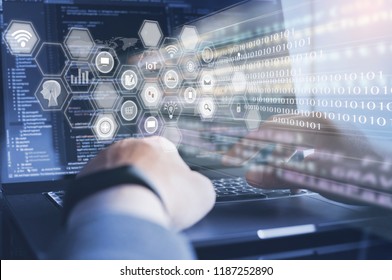 IoT Internet of Things, Digital software development, Mobile app computer coding concept. Programmer coding HTML javascript on laptop computer with web icons, modern tech, big data on virtual screen.