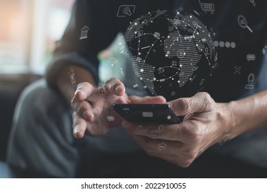 IoT Internet of Things, mobile apps development, digital marketing, online shopping, E-commerce, omnichannel concept. Man using mobile phone with technology icons and global network on virtual screen