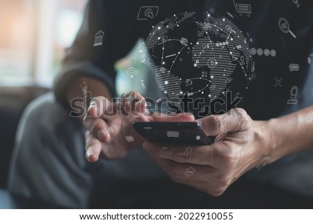 IoT Internet of Things, mobile apps development, digital marketing, online shopping, E-commerce, omnichannel concept. Man using mobile phone with technology icons and global network on virtual screen