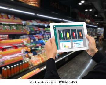 Iot Smart Retail In The Futuristic Concept, The Retailer Hold The Tablet And Use Augmented Reality Technology Monitor Data Of Out Of Shelve, Price, Planogram, Campaign Of Compliance In The Real Time