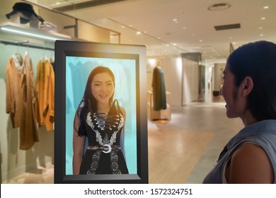 iot smart retail futuristic technology concept, happy girl try to use smart display with virtual or augmented reality  in the shop or retail to choose select ,buy cloths and give a rating of products 