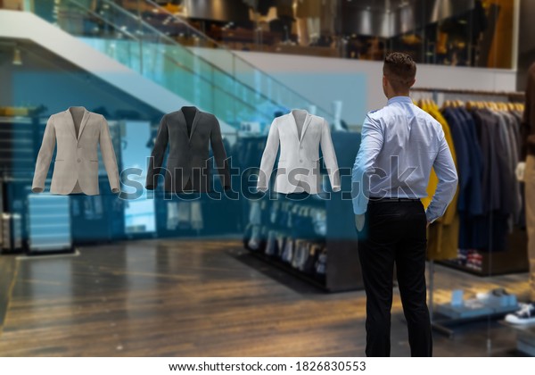 iot smart retail futuristic technology concept, happy\
man try to use smart display with virtual or augmented reality  in\
the shop or retail to choose select ,buy cloths and give a rating\
of products 