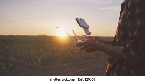 IoT(Internet of Things) smart agriculture industry 4.0 concept.Farmer with drone remote controller in farm. Drone for agriculture and analysis Aerial view of field. - Powered by Shutterstock