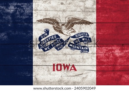 Iowa State flag on a wooden surface. Banner of the grunge Iowa State flag. 