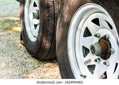 Iowa, USA - June 8, 2019: Twin Tandem Axle Trailer Tires Under Load And Chocked