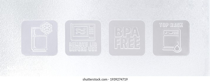 Iowa, USA-Mar 19, 2021: Closeup Safety Information Symbol On Frosted Plastic Food Tupperware. Set Of Care And Safe Icon On Reusable Packaging For Using In Freezer, Microwave, Dish Washer And Bpa Free.