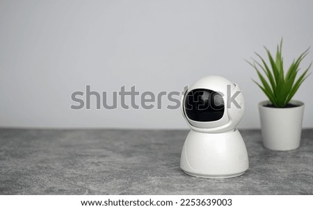 IP Camera.  CCTV wireless IP security camera with 360 degrees rotating head, Concept of home security system for surveillance and protection, controlling via smartphone online.                        