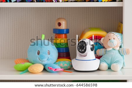 IP camera on the shelf with toys, serving as a baby monitor