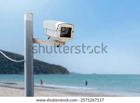 ip cctv camera installed on metal pole beside the sea beach to do the security by monitoring through mobile phone and computer to save human life and property, soft and selecitve focus.