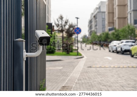 IP surveillance camera on a pole near the gate. Barrier monitoring and control