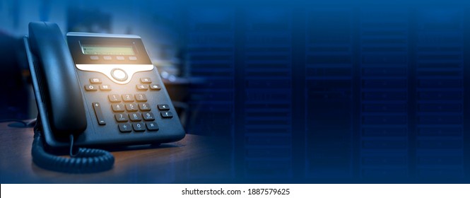 IP telephone device on blurred data center background with copy space, web banner or header design