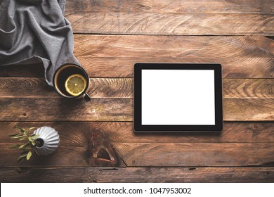 Ipad, digital tablet and cup of tea on wooden table, background. Mock up.  - Powered by Shutterstock