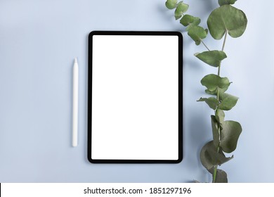 IPad Pro With White Screen On Blue Background With Apple Pencil. Flat Lay