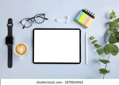 iPad pro with white screen, pencil and watch on blue color background. Flatlay. Office background - Powered by Shutterstock