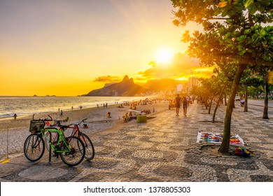 Ipanema beach with mosaic of sidewalk in Rio de Janeiro, Brazil. Ipanema beach is the most famous beach of Rio de Janeiro, Brazil. Sunset cityscape of Rio de Janeiro - Powered by Shutterstock