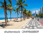 Ipanema beach with palms and mosaic of sidewalk in Rio de Janeiro, Brazil. Ipanema beach is the most famous beach of Rio de Janeiro, Brazil. Cityscape of Rio de Janeiro.