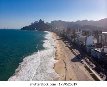 Ipanema and Leblon beach at sunset with people reappearing during COVID-19 coronavirus outbreak. Aerial cityscape of Rio de Janeiro reopening public spaces. [June 18, 2020]