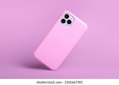 IPhone 11 And 12 Pro Max In Pink Silicone Case Falls Down Back View, Phone Case Mockup Isolated On Pink Background