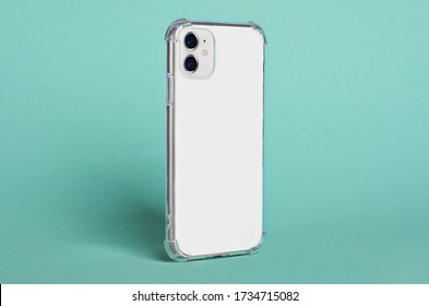 IPhone 11 Case Mock Up Side View. White IPhone 12 Smartphone In Clear Silicone Case Isolated On Green Background, Rotated Position. Smartphone Perspective View