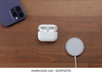 iphone 14 pro max, airpods pro, magsafe charger. white wireless headphones, smartphone, wireless charging