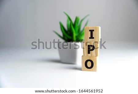 IPO - acronym from wooden blocks with letters, Initial Public Offering IPO concept, random letters around, white background