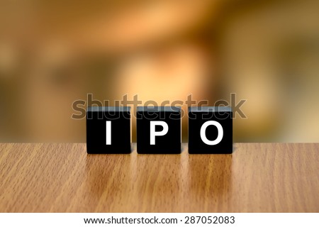IPO or Initial public offering on black block with blurred background