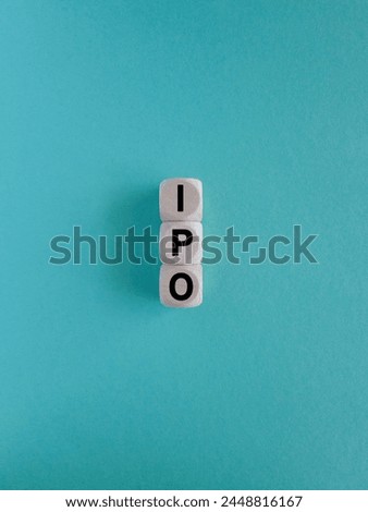 IPO- Initial Public Offering symbol. Concept word IPO on wooden cubes. Beautiful blue background. Business and IPO concept. Copy space.