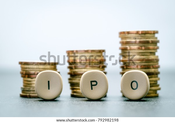 IPO letter blocks  and stacked coins. IPO\
stands for Initial Public\
Offering.