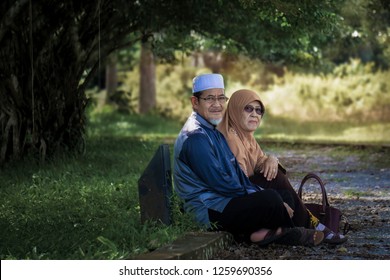 Ipoh, Malaysia - December 11, 2018 : Asian Muslim Old Couple Enjoy The Nature In A Park During Sunny Day In Perak.