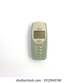 Ipoh, Malaysia - February 09, 2021: The Finnish made cellular phone Nokia 3315 isolated on white background. Image contains noise and film grain due to higher ISO setting.