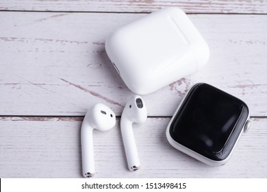 Ipoh, Perak, Malaysia, 20 September 2019 - Airpods And Apple Watch Body Flat Lay Composition On White Wooden Background.