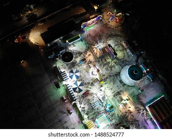 Ipoh, Perak, Malaysia, Circa July 2019 - Aerial View And Top Down Fun Park Including Carousel Merry Go Round At Night. Image Contain Certain Grain Or Noise And Soft Focus.